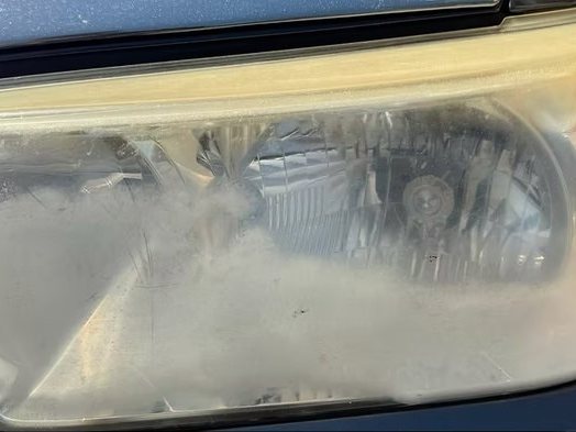 Toyota Tacoma headlight before restoration, yellowed and hazed over